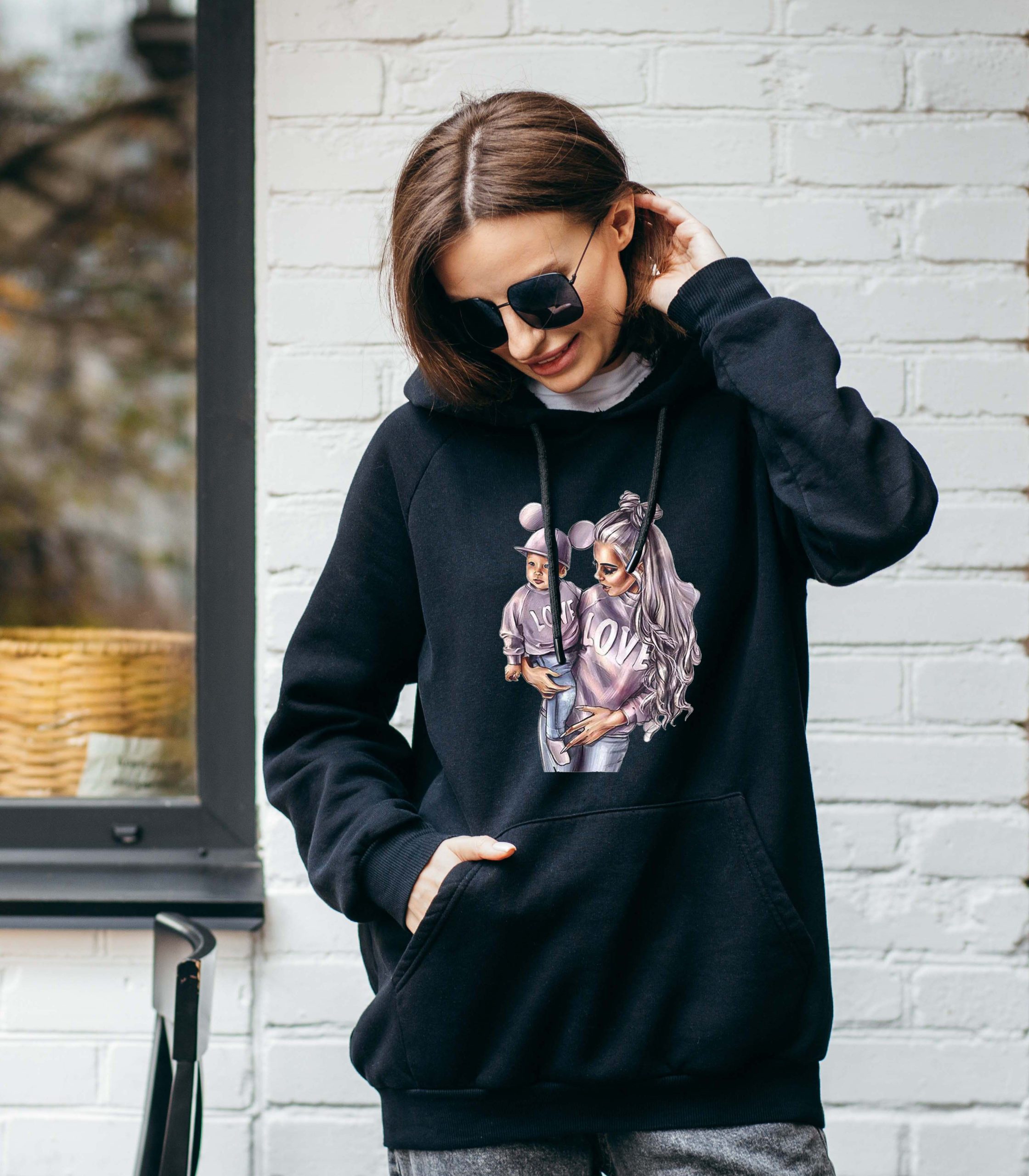 Young woman in glasses and black hoodie